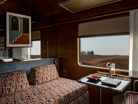 La Dolce Vita Orient Express - Deluxe cabin with sofa in daytime configuration. | © La Dolce Vita Orient Express