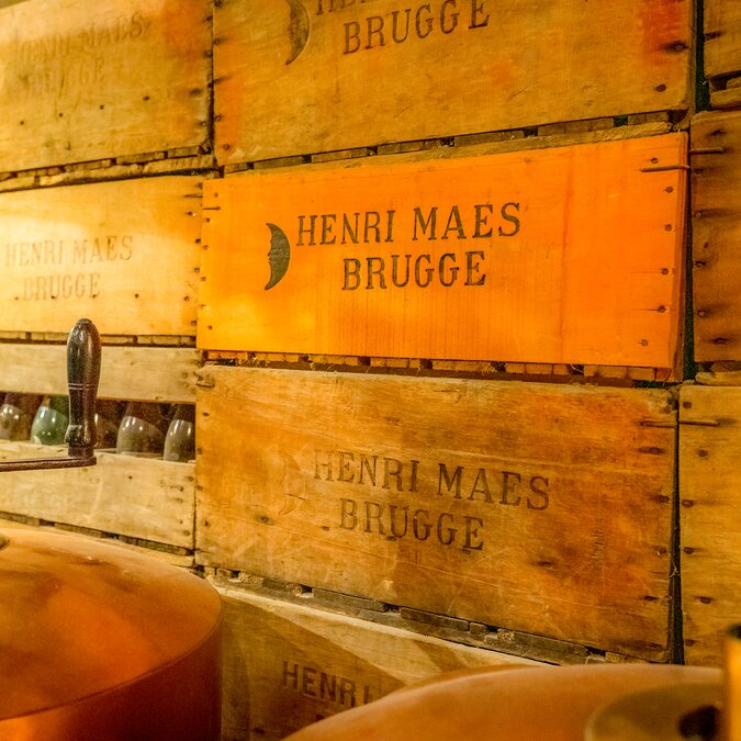 Wooden crates labeled “Henri Maes Brugge” in the traditional De Halve Maan brewery. | © Jan Darthet – Bruges, De Halve Maan Brewery