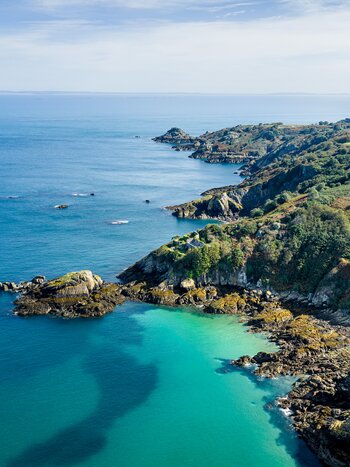Bouley Bay with the fields, headland and cliffs and Fort Leicester