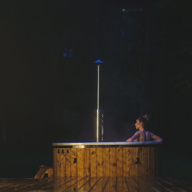 Young women cool off at night in nature in a hot SPA tub. | © Shutterstock 2306476535