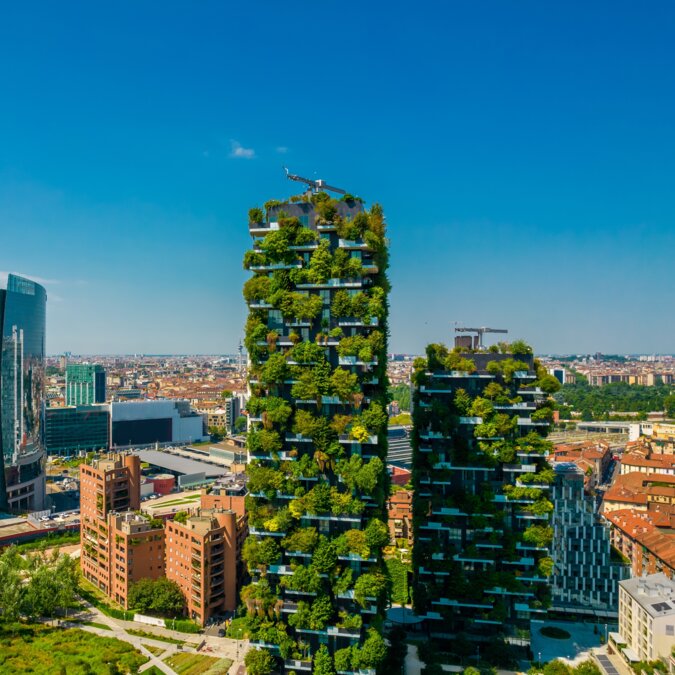 Aerial view of Bosco Verticale in Milan Porta Nuova, also known as Vertical Forest Buildings. Residential building with many trees and other plants on balconies | © Shutterstock 2155805223